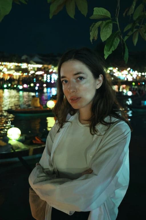 a portrait of a person with a pure cyan and magenta neon outline glow, creating a vibrant double exposure effect against a dark background