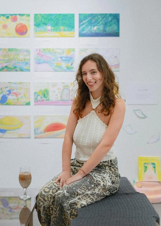 a portrait of a person surrounded by floating 3D geometric shapes (cubes, pyramids) in pastel colors against a gradient background