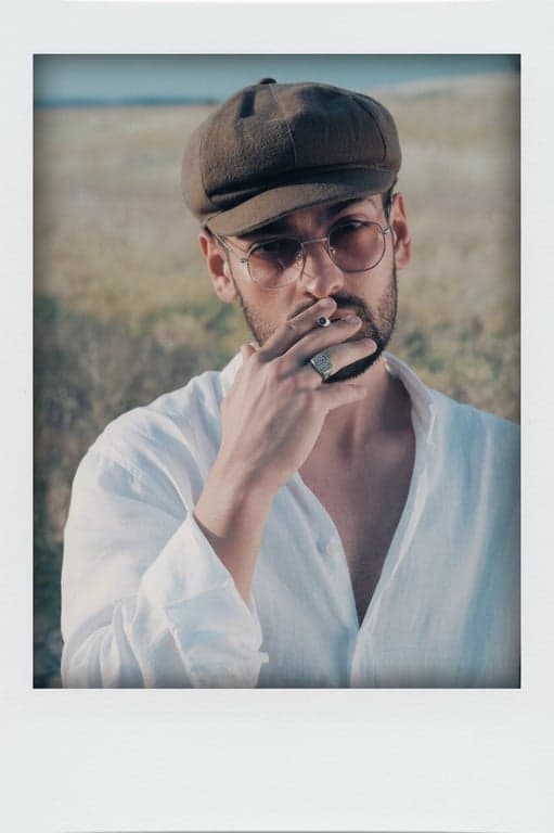 a portrait of a person styled with classic Polaroid visuals, showing pastel-like colors, even exposure, gentle edge fade, and subtle film softness