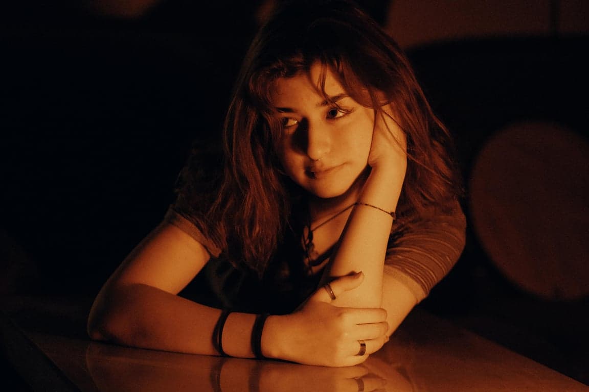 a portrait of a person illustrated in a modern shoujo anime style focusing on emotional softness, clean composition, and light pastel tones