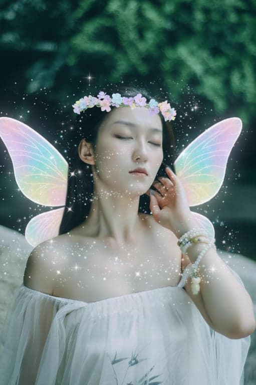 a portrait of a woman with a fairy kawaii filter, adding pastel wings, flower crown, and magical sparkle dust around the face