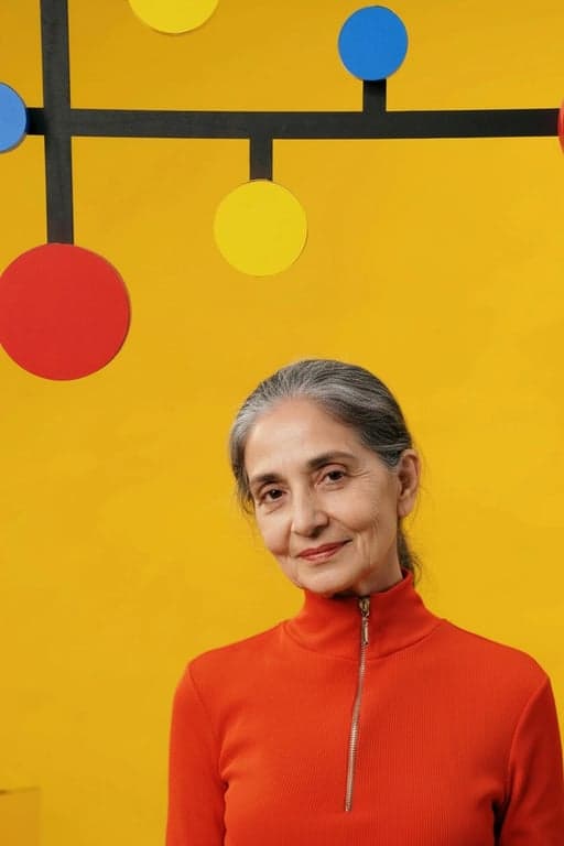 age ai generator after photo - woman wearing red hoodie in her 70s