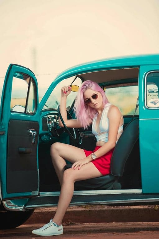 a portrait of a person edited to have pastel pink hair, with subtle tonal variation from roots to tips, controlled saturation, visible strand detail, and natural scalp blending