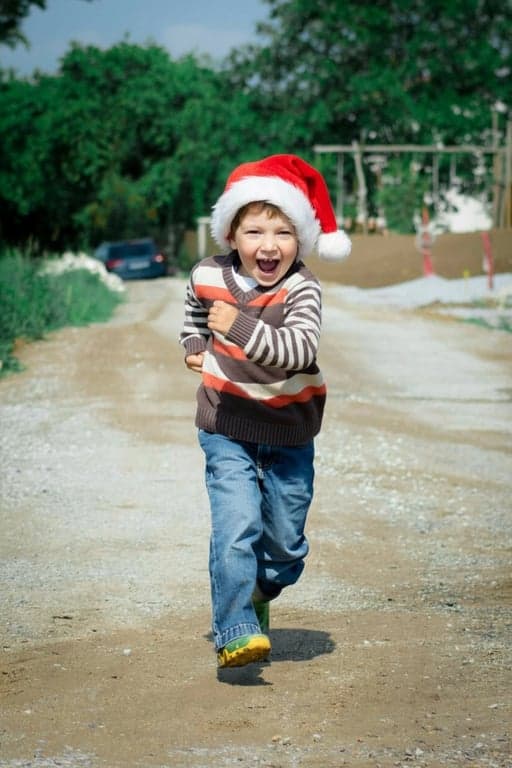 AI baby Christmas photo after photo - kid running towards the camera with Christmas decoration
